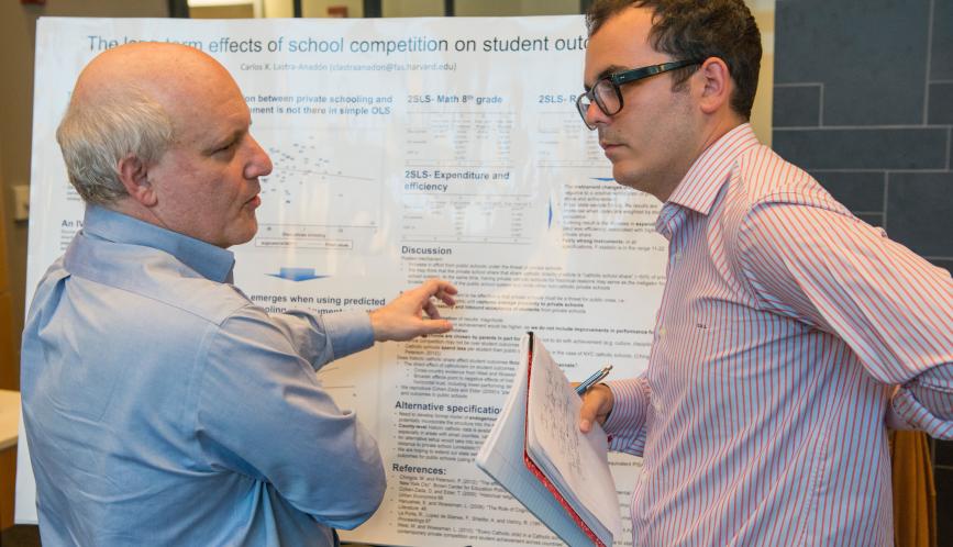 Steven Durlauf discussing a student's poster.