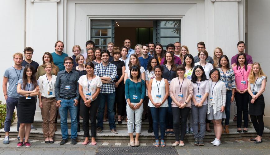 A group image of all the summer school students and faculty, standing outside the briq building.