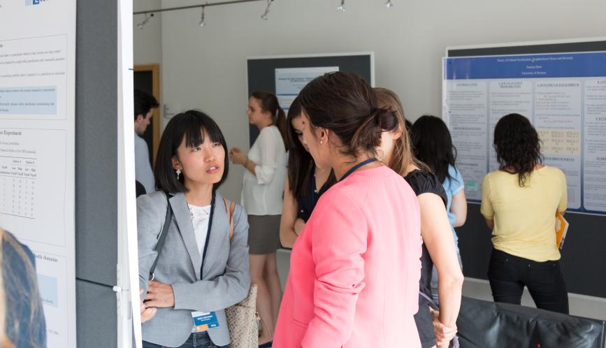 Students in discussion during a summer school poster session.