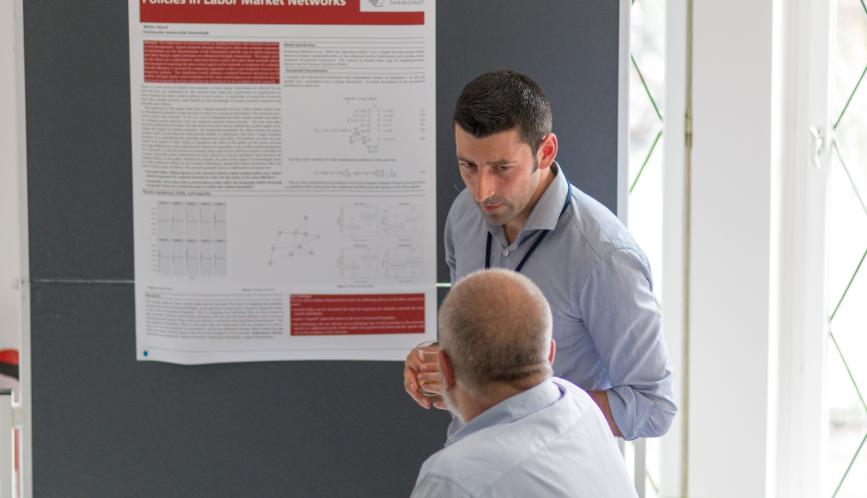 A student presents his work during poster sessions.