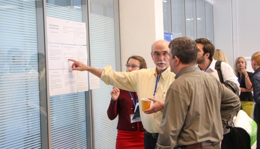 Larry Blume discusses a student's research during poster sessions.