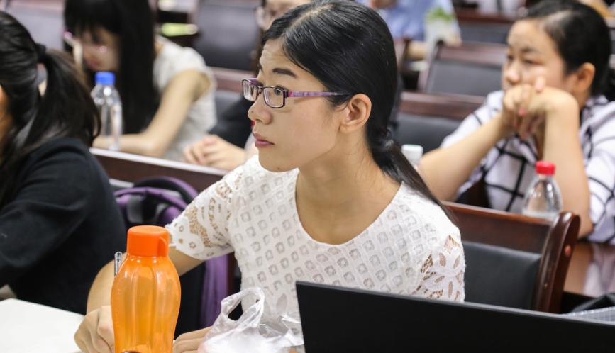 A close up of a student watching a lecture.