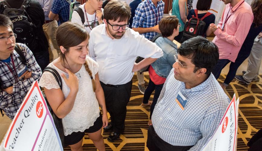 Students in discussion during poster sessions.