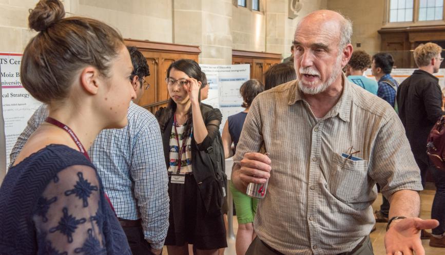 Larry Blume in conversation with a student during poster sessions.