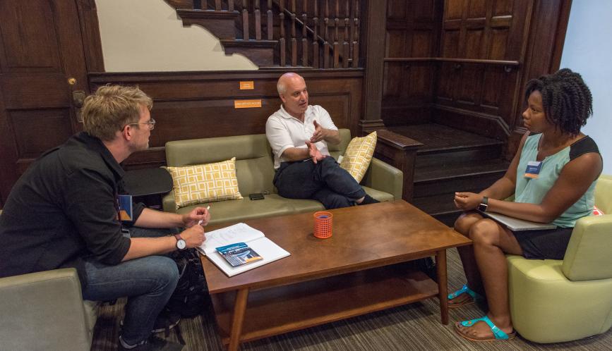 Steven Durlauf meets with two students during office hours.