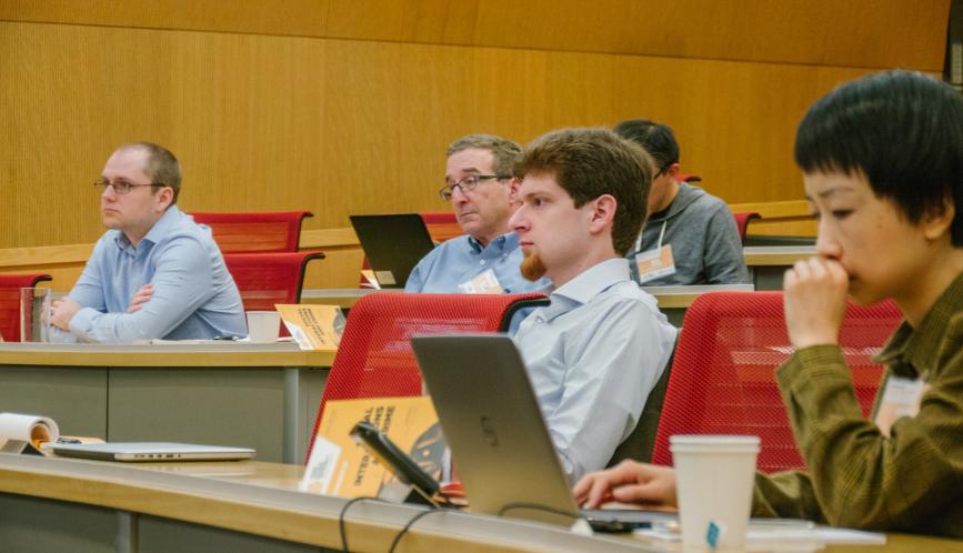 Conference attendees watching a session.