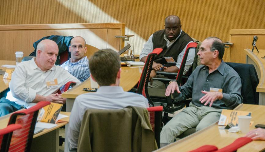 Conference participants in conversation in the classroom.