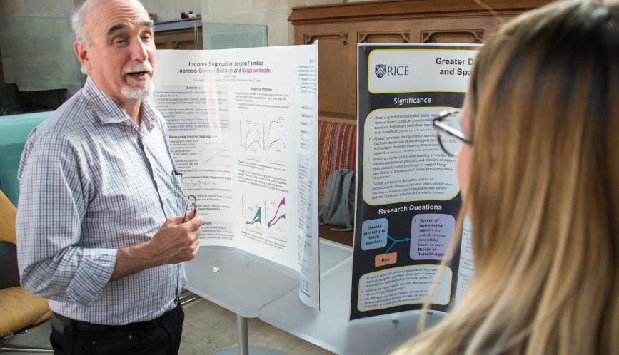 Larry Blume in conversation with a student during poster sessions.