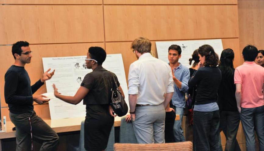 A group of students in conversation during poster sessions.
