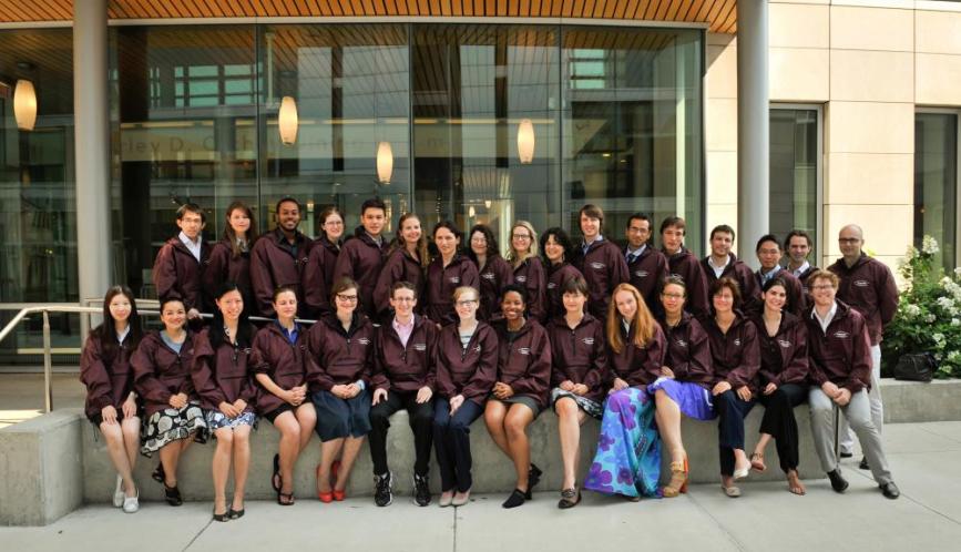 A group shot of all the students and lecturers of summer school, wearing matching jackets.