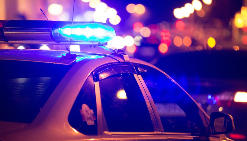 A stock image of a police car with its lights flashing.