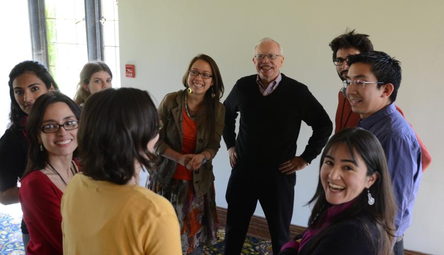 A group shot including James Heckman and several conference attendees posing for the camera.