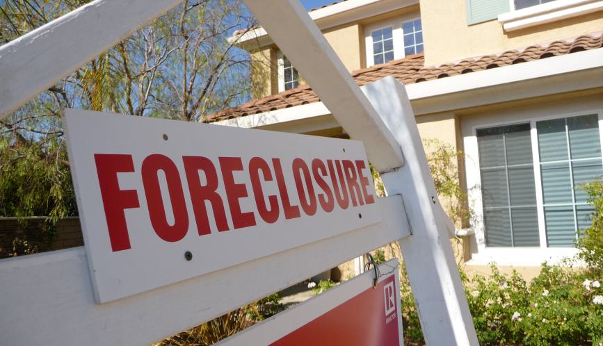 Foreclosure sign in front of house.