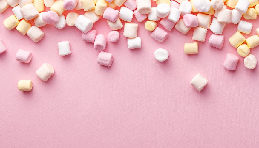 Marshmallows on pink background.