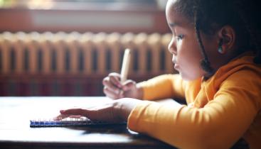 Child writing at a desk
