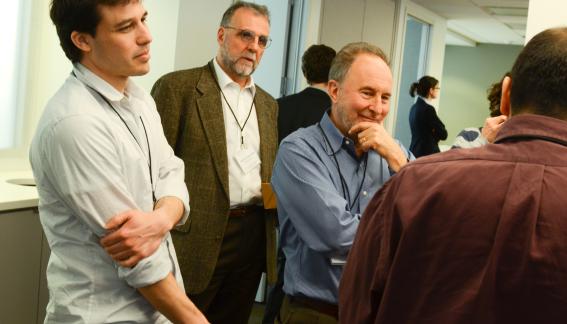 Ariel Roginsky and other conference attendees in conversation.