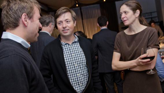 Conference attendees speaking during the reception.