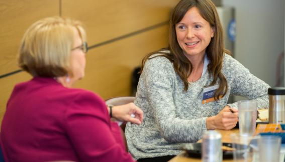 Two conference attendees in conversation.