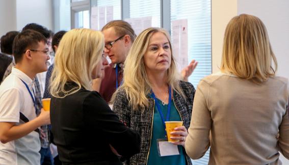 Petra Todd looking at a student's research during poster sessions.