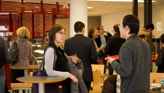 A group of conference attendees standing and talking.